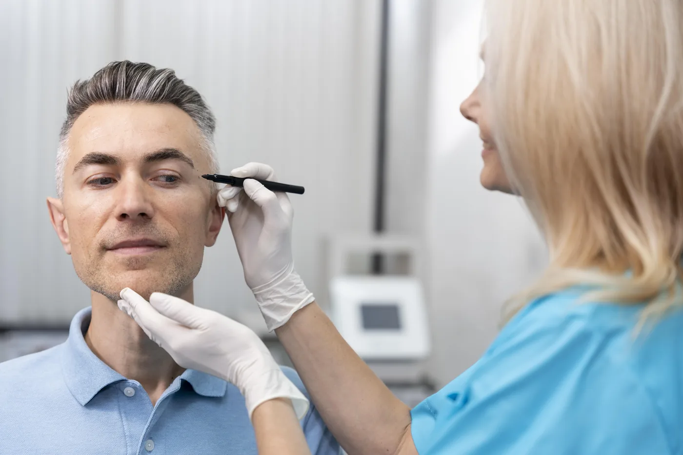 A man having his brow assessed before treatment